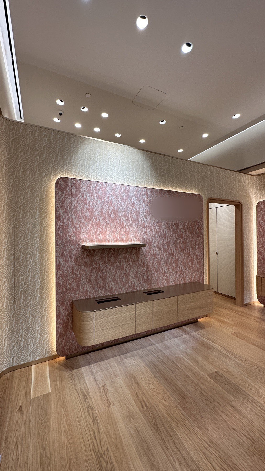 Branded feature wall with integrated shelving and lighting